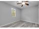 Bedroom showcasing a ceiling fan, a window with natural light, and wood-style floors at 110 E Lauren Ct, Fern Park, FL 32730