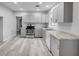 Modern kitchen featuring gray cabinets, granite counters, and stainless steel appliances at 110 E Lauren Ct, Fern Park, FL 32730