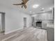 Open-concept kitchen featuring gray cabinets, modern appliances, and stylish lighting at 110 E Lauren Ct, Fern Park, FL 32730