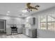 Well-lit kitchen featuring gray cabinets, modern appliances, and a fan on the ceiling at 110 E Lauren Ct, Fern Park, FL 32730