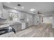Bright kitchen features gray cabinets, granite countertops, stainless steel appliances, and a large window for natural light at 110 E Lauren Ct, Fern Park, FL 32730