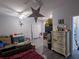 Open-concept living room with unique decor, including star lights and dressers at 110 E Lauren Ct, Fern Park, FL 32730