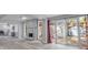 Open-concept living space with a stone fireplace, kitchen view, and sliding door to backyard at 110 E Lauren Ct, Fern Park, FL 32730