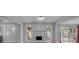 Open-concept living space showing stylish flooring, a stone fireplace, and a sliding door to backyard at 110 E Lauren Ct, Fern Park, FL 32730