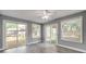 Living room with multiple sliding glass doors with a backyard view, natural light, and wood-style floors at 110 E Lauren Ct, Fern Park, FL 32730