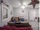 Open-concept living room with ceiling fan, window, and decorative items at 110 E Lauren Ct, Fern Park, FL 32730