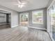 Living room featuring multiple sliding glass doors with a backyard view, natural light, and wood-style floors at 110 E Lauren Ct, Fern Park, FL 32730