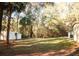 View of the backyard with storage shed and ample shade trees at 20732 Sw Marine Blvd, Dunnellon, FL 34431