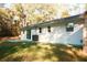 The backyard is expansive with plenty of green grass and full sun exposure and leads up to a tree line at 20732 Sw Marine Blvd, Dunnellon, FL 34431