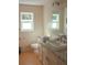 Well-lit bathroom showcasing a vanity with a bright countertop, toilet, and large mirror at 20732 Sw Marine Blvd, Dunnellon, FL 34431