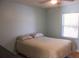 Bedroom featuring a comfortable bed, light blue walls, and a bright window at 20732 Sw Marine Blvd, Dunnellon, FL 34431