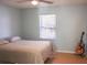Bedroom with light blue walls, bright window, and a guitar at 20732 Sw Marine Blvd, Dunnellon, FL 34431