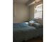 Bedroom featuring a blue comforter, overhead lighting, and natural light at 20732 Sw Marine Blvd, Dunnellon, FL 34431