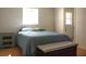 Bright bedroom with blue bedding, side table, and wooden bench at 20732 Sw Marine Blvd, Dunnellon, FL 34431