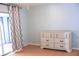 Bedroom with white dresser, patterned curtains and natural lighting at 20732 Sw Marine Blvd, Dunnellon, FL 34431