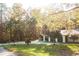 Charming single-story home featuring a manicured lawn, mature trees, and a convenient carport at 20732 Sw Marine Blvd, Dunnellon, FL 34431
