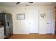 Kitchen area with a refrigerator, white doors, and a view of an adjacent room at 20732 Sw Marine Blvd, Dunnellon, FL 34431