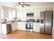 Modern kitchen featuring stainless steel appliances, white cabinets, and solid countertops at 20732 Sw Marine Blvd, Dunnellon, FL 34431