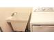 A utility sink next to a white dryer in the laundry room at 20732 Sw Marine Blvd, Dunnellon, FL 34431