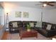 Inviting living room with large brown leather sectional sofa and modern decor at 20732 Sw Marine Blvd, Dunnellon, FL 34431