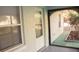Enclosed porch entrance featuring a full view storm door, exterior window and planted flower bed at 20732 Sw Marine Blvd, Dunnellon, FL 34431