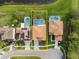 Aerial view of a home with a screened-in pool, bordered by lush greenery and a serene pond at 460 Tess Ct, Orlando, FL 32834