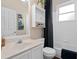 Bathroom with a white sink, white tile tub/shower, and wood-look flooring at 460 Tess Ct, Orlando, FL 32834