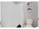 Bright bathroom with white tiled walls and a combined tub and shower at 460 Tess Ct, Orlando, FL 32834