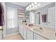 Bathroom with a long double vanity, large mirror, and neutral walls at 460 Tess Ct, Orlando, FL 32834