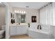 Bathroom featuring a large soaking tub, dual vanity sinks, and a separate shower for a spa-like experience at 460 Tess Ct, Orlando, FL 32834