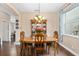 Formal dining room showcasing beautiful hardwood floors, a classic chandelier, and a built-in china cabinet at 460 Tess Ct, Orlando, FL 32834