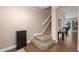 Warm and inviting entryway featuring carpeted stairs, a coat rack, and wood-look flooring at 460 Tess Ct, Orlando, FL 32834