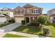 Charming two-story home featuring a well-manicured lawn and attached two-car garage at 460 Tess Ct, Orlando, FL 32834