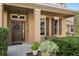 Inviting front entrance with a double door, complemented by a wreath and decorative landscaping at 460 Tess Ct, Orlando, FL 32834