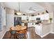 Open-concept kitchen featuring white cabinetry, granite countertops, and stainless steel appliances that offers space at 460 Tess Ct, Orlando, FL 32834