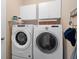 Convenient laundry room with white washer and dryer, and overhead cabinets that maximizes storage at 460 Tess Ct, Orlando, FL 32834