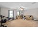 Large bonus room with carpet flooring, ceiling fan, and couches by two windows at 460 Tess Ct, Orlando, FL 32834