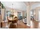 Open-concept living and dining room with hardwood floors and neutral color palette providing a relaxing atmosphere at 460 Tess Ct, Orlando, FL 32834