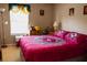 Cozy bedroom featuring a bright window with patterned curtains and colorful comforter on the bed at 4720 Vero Beach Pl, Kissimmee, FL 34746