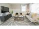 Comfortable living room with plush seating, modern decor, and a decorative rug at 5884 Meditation Dr, Clermont, FL 34714