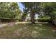 Large backyard with mature trees, a shed, and plenty of green space at 5932 Hilltop E Ln, Lakeland, FL 33809