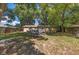 View of the backyard with patio furniture, a firepit, and a well-maintained lawn at 5932 Hilltop E Ln, Lakeland, FL 33809