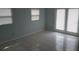Bedroom with tile floors, natural light from a window and access to the exterior through glass doors at 5932 Hilltop E Ln, Lakeland, FL 33809