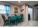Bright dining area featuring blue accents, natural light, and easy access to the laundry area at 5932 Hilltop E Ln, Lakeland, FL 33809