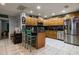 Spacious kitchen with stainless steel appliances, tile flooring, and wood cabinets at 5932 Hilltop E Ln, Lakeland, FL 33809