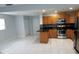 Modern kitchen with stainless steel appliances, granite countertops, and tile floors at 5932 Hilltop E Ln, Lakeland, FL 33809