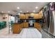 Modern kitchen with stainless steel appliances, wooden cabinetry, granite countertops, and tile backsplash at 5932 Hilltop E Ln, Lakeland, FL 33809