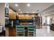 Modern kitchen with stainless steel appliances, wooden cabinetry, granite countertops, and tile backsplash at 5932 Hilltop E Ln, Lakeland, FL 33809