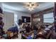 Cozy living room with a modern entertainment setup, guitars, and natural light at 5932 Hilltop E Ln, Lakeland, FL 33809