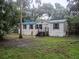 Traditional single-story home with lush landscaping and a welcoming front entrance at 6736 Cr 772, Webster, FL 33597